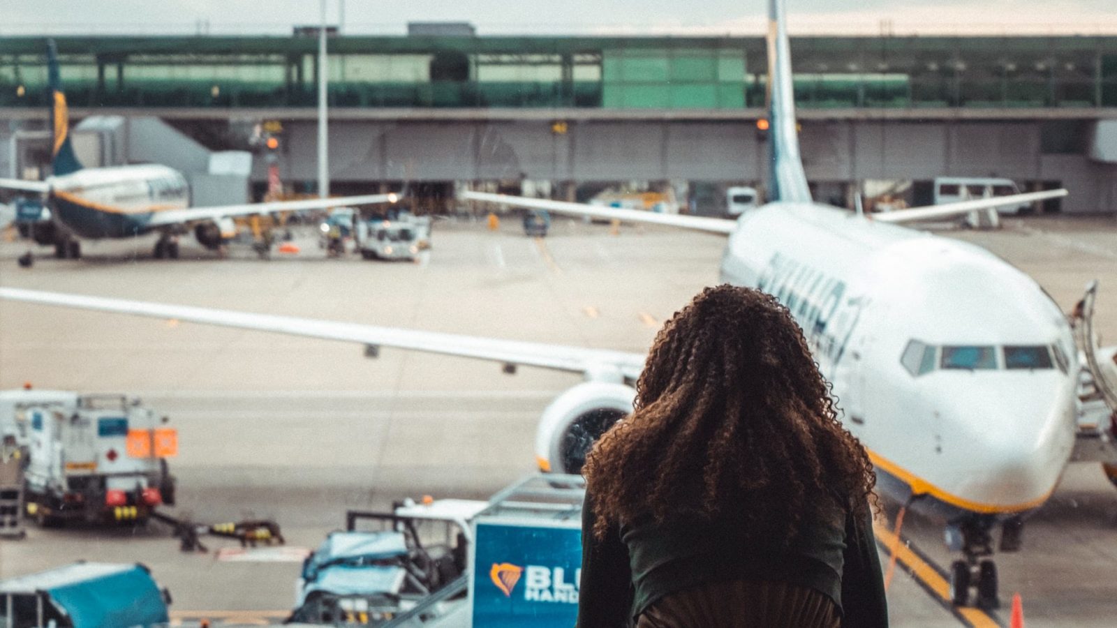 Person looking out airport terminal window