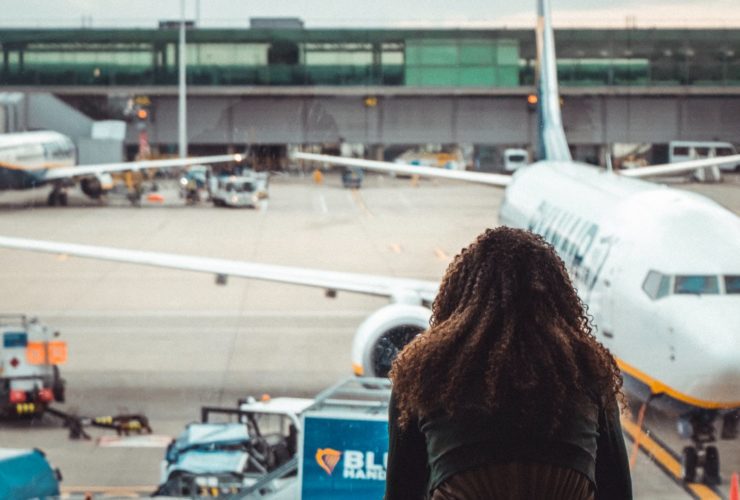 Person looking out airport terminal window