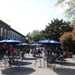 Historic riverwalk in Savannah with places to eat and tables