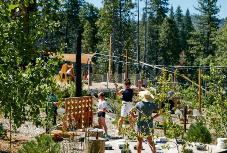 guests playing supersized Connect 4 at Rush Creek Lodge near Yosemite National Park