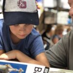 grandparent and grandchild looking at map of Barcelona at a cafe in the city's Gracia neighborhood