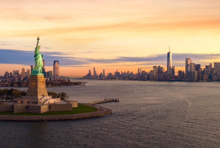 beautiful sky and New York City in background with Statue of Liberty in foreground