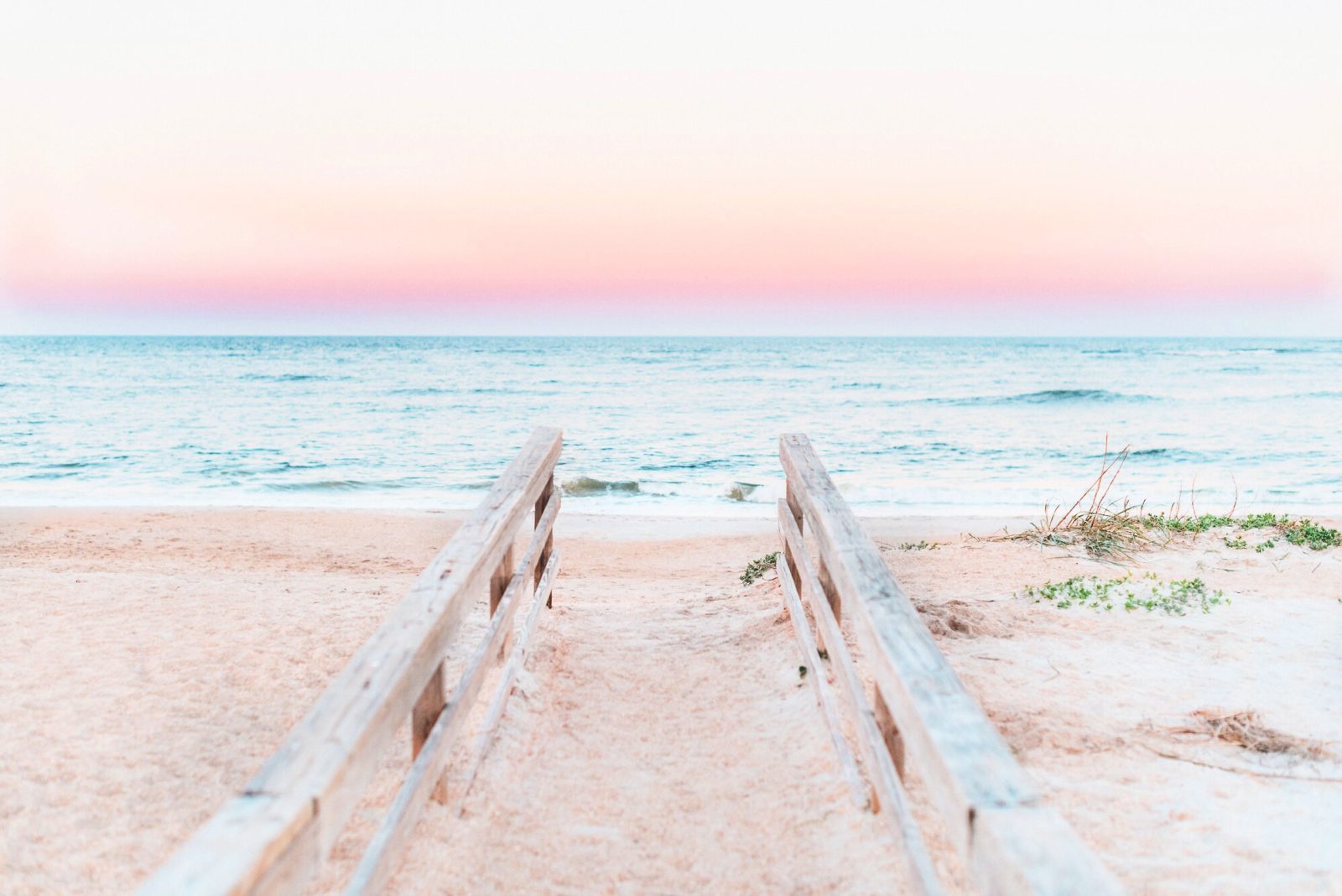 railings leading down to beach at sunset in St. Augustine, Florida