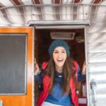 Woman poking her head out of a vintage RV (Photo: @jordvdz via Twenty20)