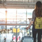 Woman at airport with carry-on luggage (Photo: Shutterstock)