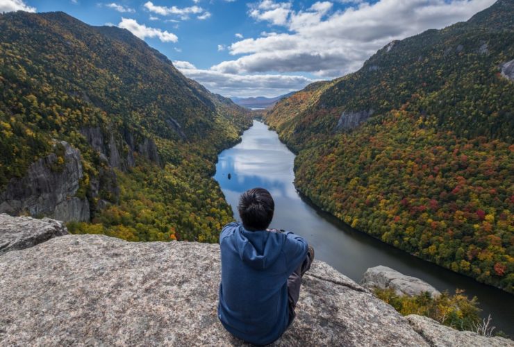 Man sitting on Indian Head Cliff at Adirondack Park, New York (Photo: Shutterstock)