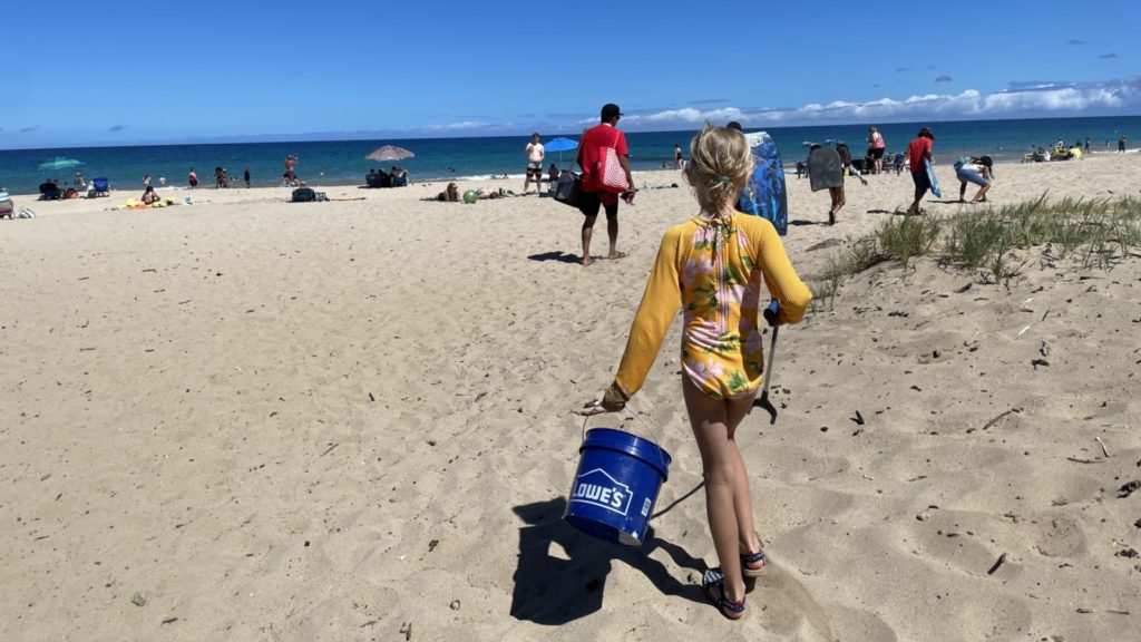 child doing a beach clean up at Hapuna Beach on the Island of Hawaii