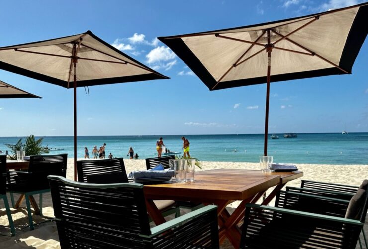 Tables in the sand at the Coccoloba Restaurant at the Seven Mile Beach resort Kimpton Seafire