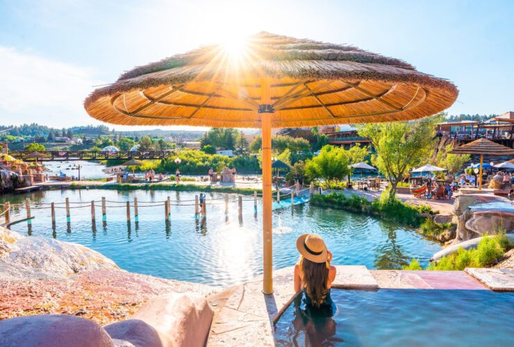 person in hot spring looking out at The Springs Resort in Colorado