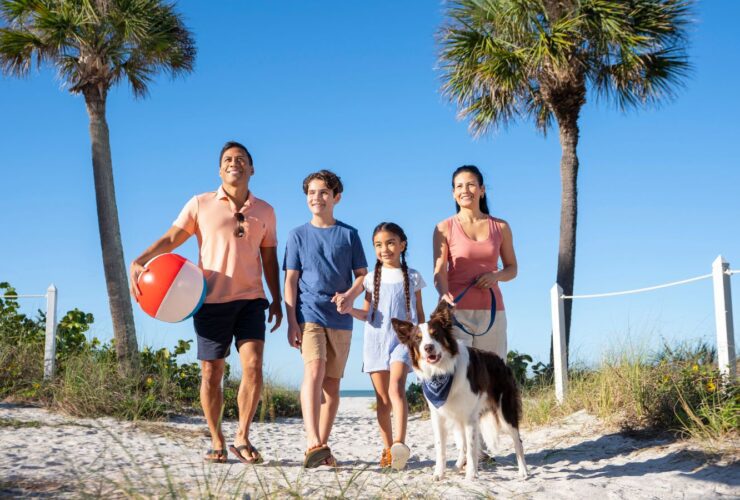 Family and dog on beach (Photo: TradeWinds Island Resort)