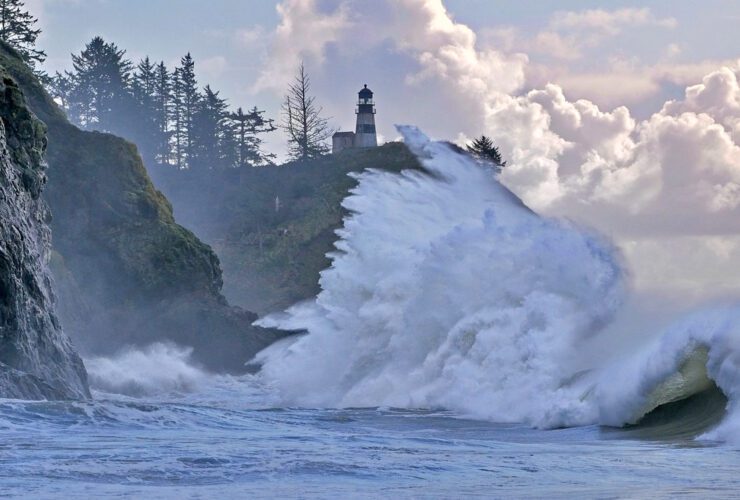 king tide crashing against the rocks below a lighthouse on Long Beach Peninsula in Washington state