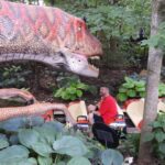 Passengers on boats encounter dinosaurs at the Columbus Zoo and Aquarium. Photo by Tim Trudell