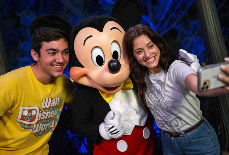 Guests with Mickey Mouse at Walt Disney World