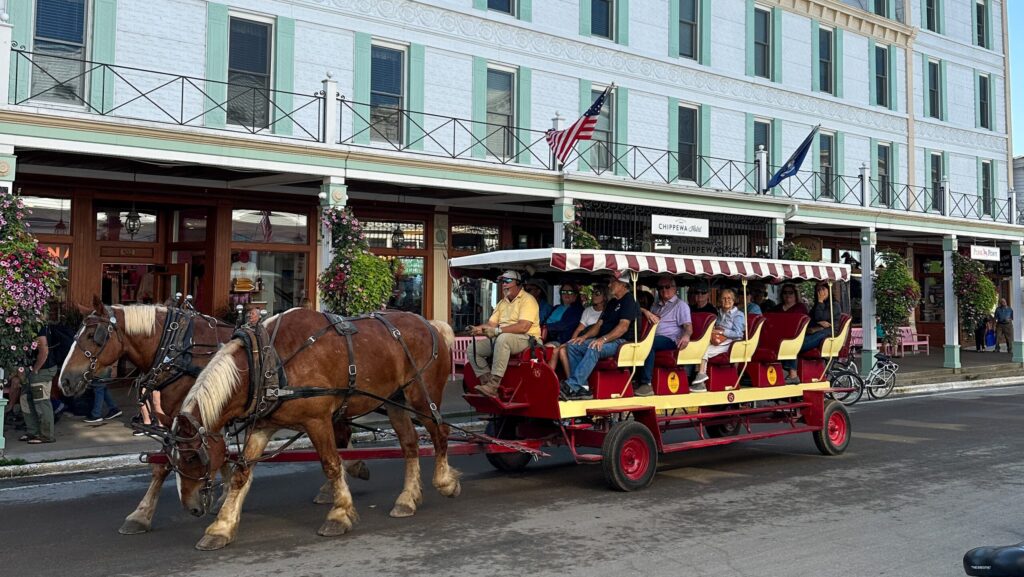 A horse-drawn carriage in front of a historic hotel on Main Street on Mackinac Island