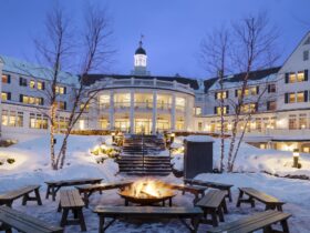 An exterior nighttime snowy view of The Sagamore Resort