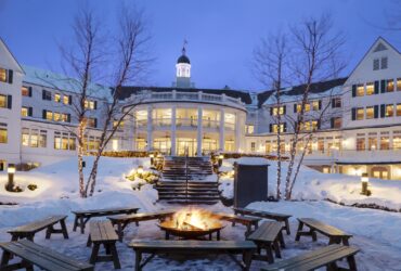 An exterior nighttime snowy view of The Sagamore Resort